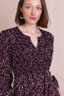 Front view of the burgundy printed smocked midi dress with long sleeves and a notch neckline.