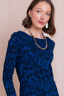 Front view of royal blue patterned knee-length dress with long sleeves